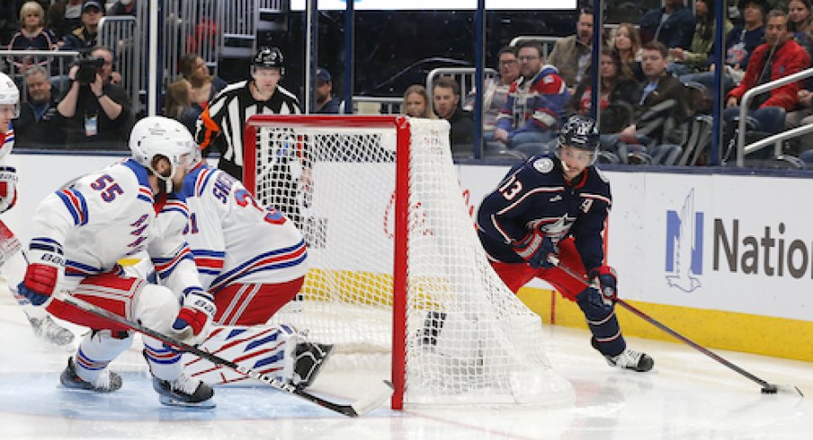 Columbus Blue Jackets left wing Johnny Gaudreau (13) looks to pass from behind the net as New York Rangers defenseman Ryan Lindgren (55) defends during the second period at Nationwide Arena.