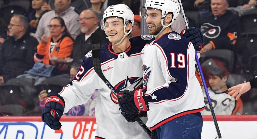 Carson Meyer and Liam Foudy celebrate a goal