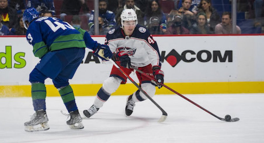 Columbus Blue Jackets forward Alexandre Texier (42) drives past Vancouver Canucks defenseman Quinn Hughes (43) in the second period at Rogers Arena.