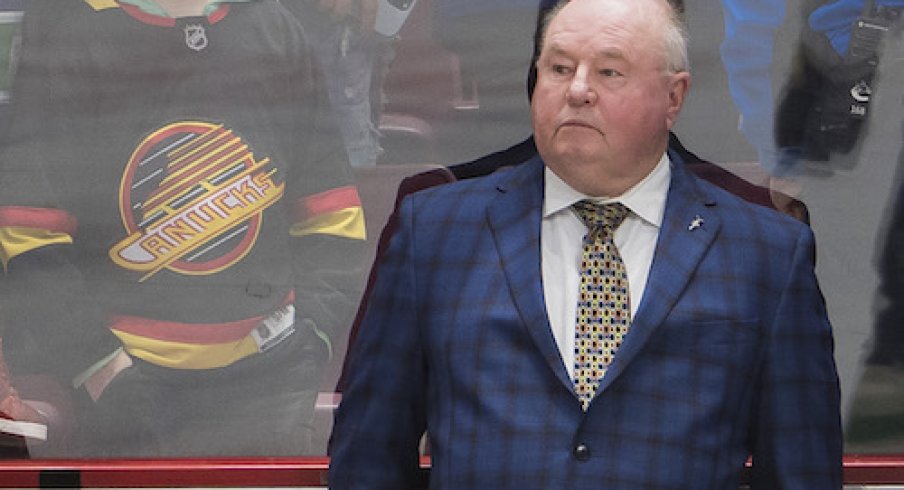 Vancouver Canucks head coach Bruce Boudreau watches from the bench during warm up prior to a game against the Arizona Coyotes at Rogers Arena.