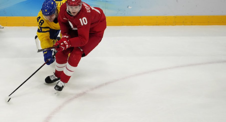 Team ROC forward Dmitri Voronkov (10) and Team Sweden forward Carl Klingberg (48) battle for the puck in the third period during the Beijing 2022 Olympic Winter Games at National Indoor Stadium