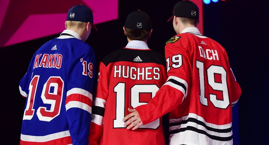 From left Kaapo Kakko (New York Rangers) , Jack Hughes (New Jersey Devils) and Kirby Dach (Chicago Blackhawks) pose with their new team jerseys after being drafted as the top three overall picks in the first round of the 2019 NHL Draft at Rogers Arena.