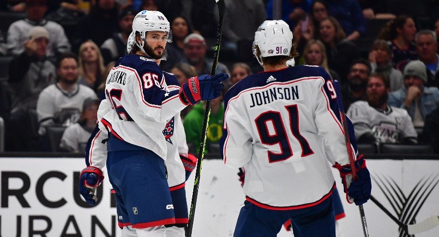 Columbus Blue Jackets right wing Kirill Marchenko (86) celebrates his goal scored against the Los Angeles Kings with center Kent Johnson (91) during the third period at Crypto.com Arena.