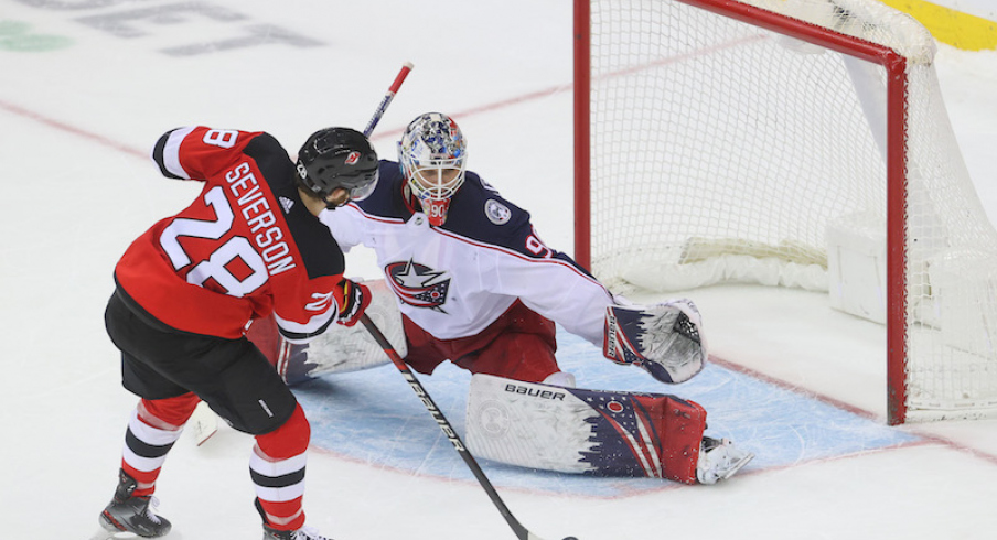 Columbus Blue Jackets' Elvis Merzlikins makes a save on New Jersey Devils' Damon Severson during the shoot out at Prudential Center.