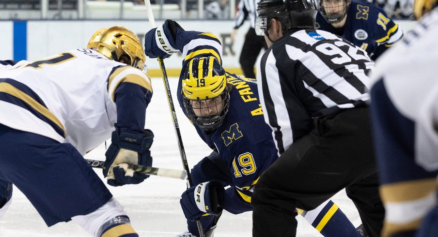 Michigan forward Adam Fantilli (19) and Notre Dame forward Jackson Pierson (11) set to face-off during the Michigan-Notre Dame NCAA hockey game on Saturday, November 12, 2022, at Compton Family Ice Arena in South Bend, Indiana.