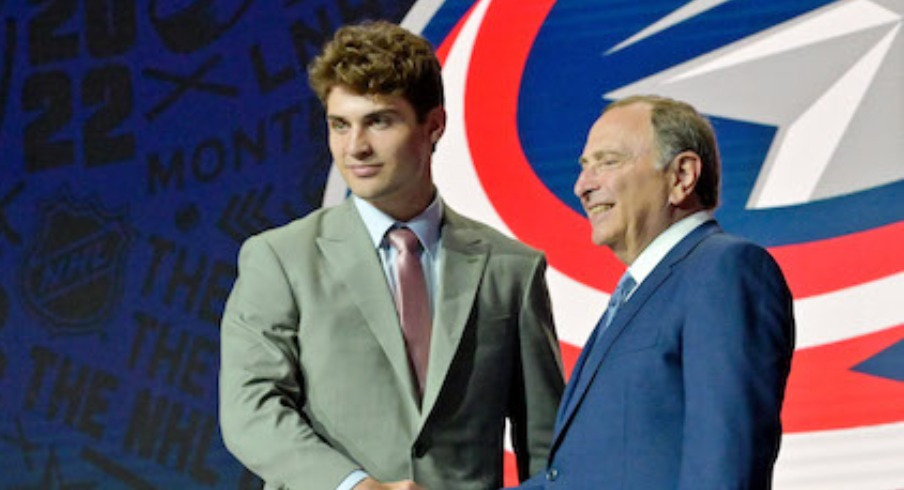 Denton Mateychuk shakes hands with NHL commissioner Gary Bettman after being selected as the number twelve overall pick to the Columbus Blue Jackets in the first round of the 2022 NHL Draft at Bell Centre.