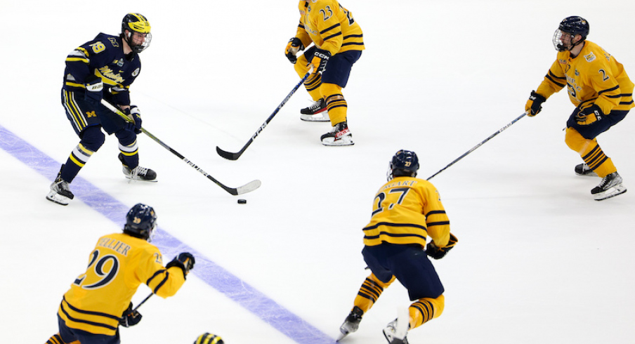 Michigan's Adam Fantilli controls the puck against Quinnipiac during the second period in the semifinals of the 2023 Frozen Four college ice hockey tournament at Amalie Arena.