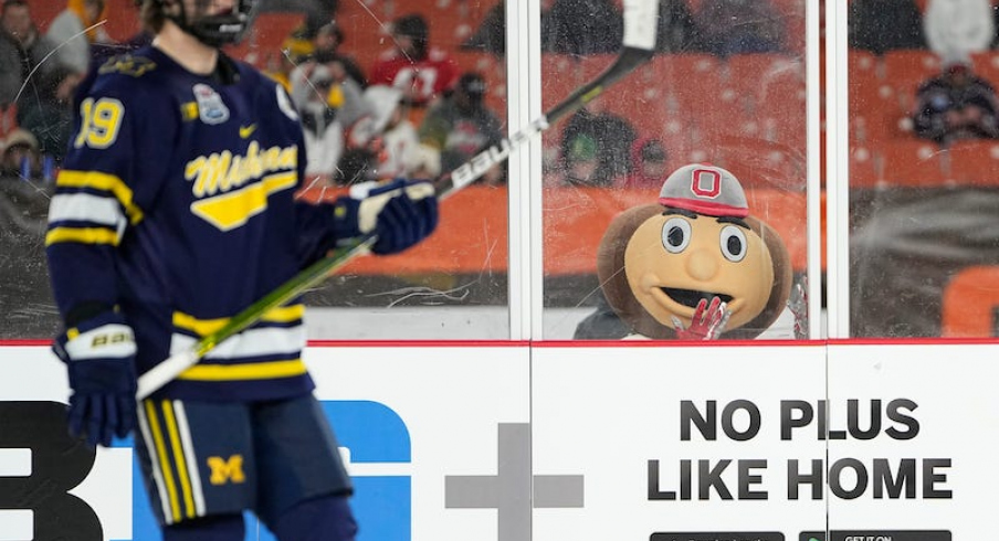 Brutus Buckeye watches Michigan Wolverines' Adam Fantilli during third period of the Faceoff on the Lake outdoor NCAA men's hockey game at FirstEnergy Stadium. Ohio State won 4-2.