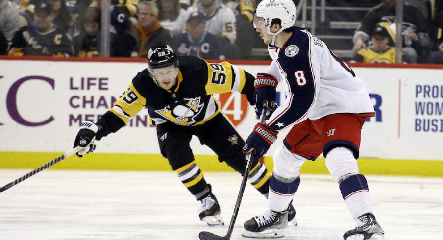 Columbus Blue Jackets' Zach Werenski moves the puck against Pittsburgh Penguins' Jake Guentzel during the third period at PPG Paints Arena