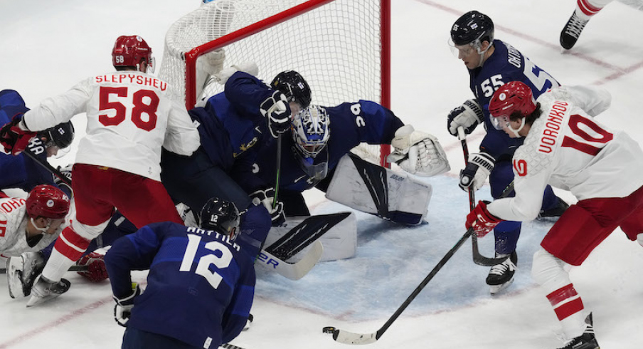 Team ROC's Dmitri Voronkov attempts to shoot the puck on Team Finland's Harri Sateri in the third period during the Beijing 2022 Olympic Winter Games at National Indoor Stadium.