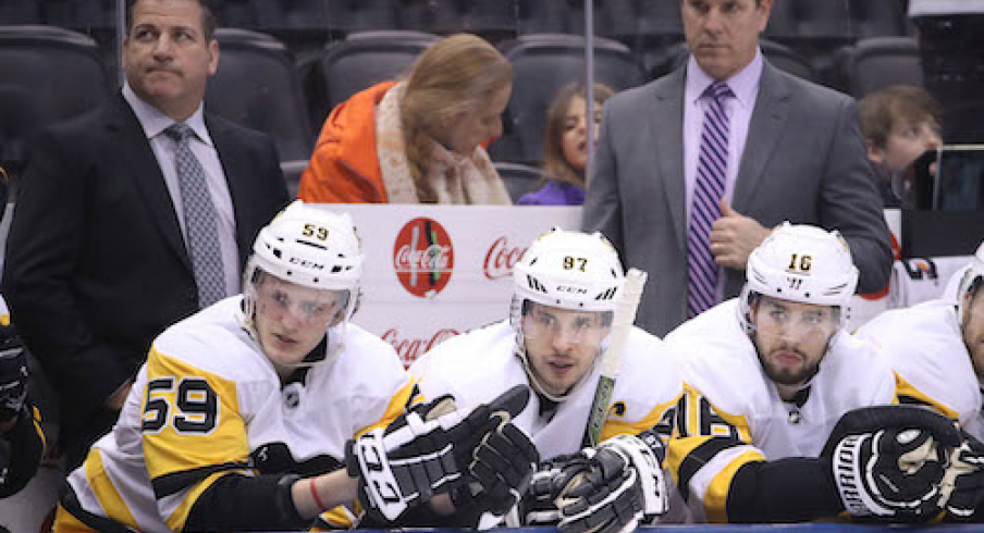 Pittsburgh Penguins center Jake Guentzel (59) and center Sidney Crosby (87) and right wing Josh Jooris (16) look on from the bench as assistant coach Mark Recchi and head coach Mike Sullivan look on against the Toronto Maple Leafs at Air Canada Centre. The Maple Leafs beat the Penguins 5-2.