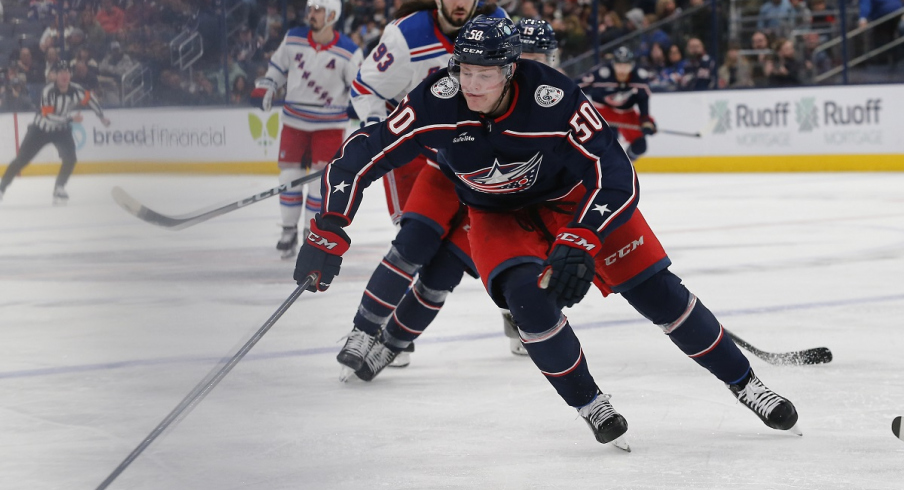 Eric Robinson gains control of a loose puck vs. the New York Rangers