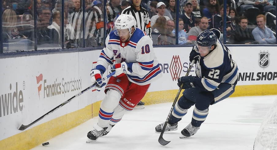 New York Rangers' Artemi Panarin skates after a loose puck as Columbus Blue Jackets' Jake Bean trails the play during the third period at Nationwide Arena.