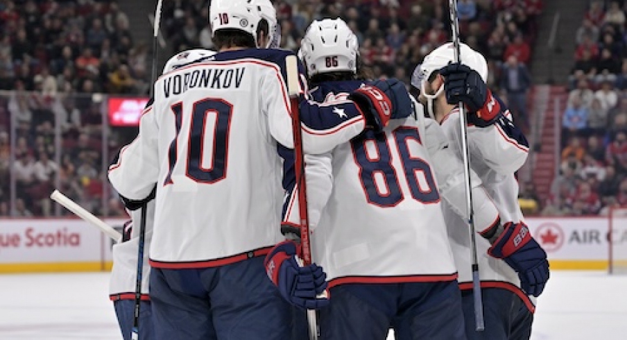 Columbus Blue Jackets forward Emil Bemstrom (52) celebrates with teammates after scoring a goal against the Montreal Canadiens during the first period at the Bell Centre.