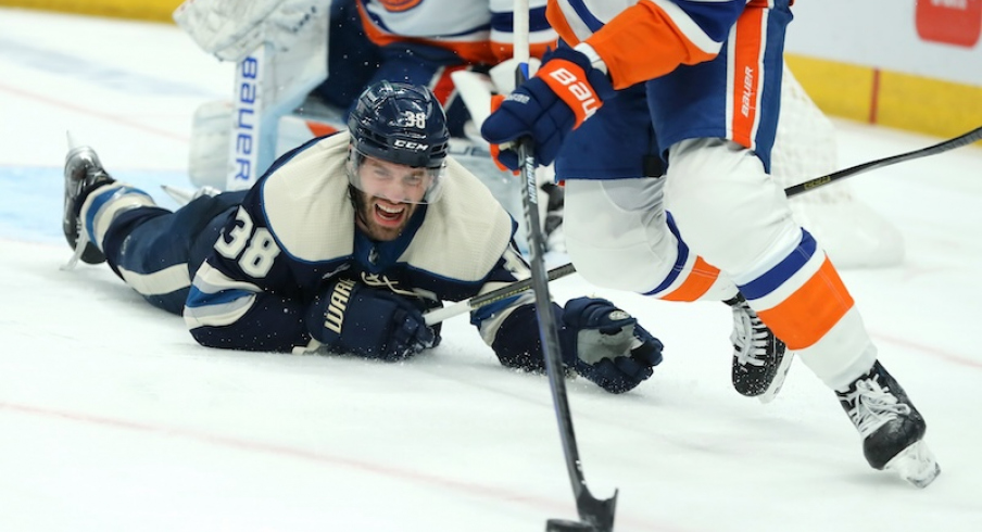 Columbus Blue Jackets' Boone Jenner looks at the loose puck as New York Islanders defenseman Adam Pelech (3) skates up the ice during the second period at Nationwide Arena.