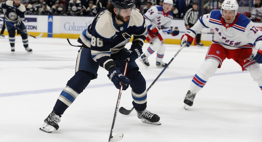 Columbus Blue Jackets' Kirill Marchenko looks to pass as New York Rangers' Nick Bonino defends during the first period at Nationwide Arena.