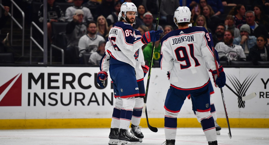 Kirill Marchenko celebrates with Kent Johnson