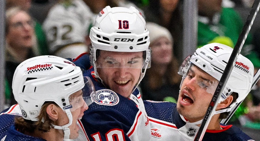 Columbus Blue Jackets center Kent Johnson (91) and left wing Dmitri Voronkov (10) and center Cole Sillinger (4) celebrates a goal Voronkov against the Dallas Stars during the first period at the American Airlines Center.