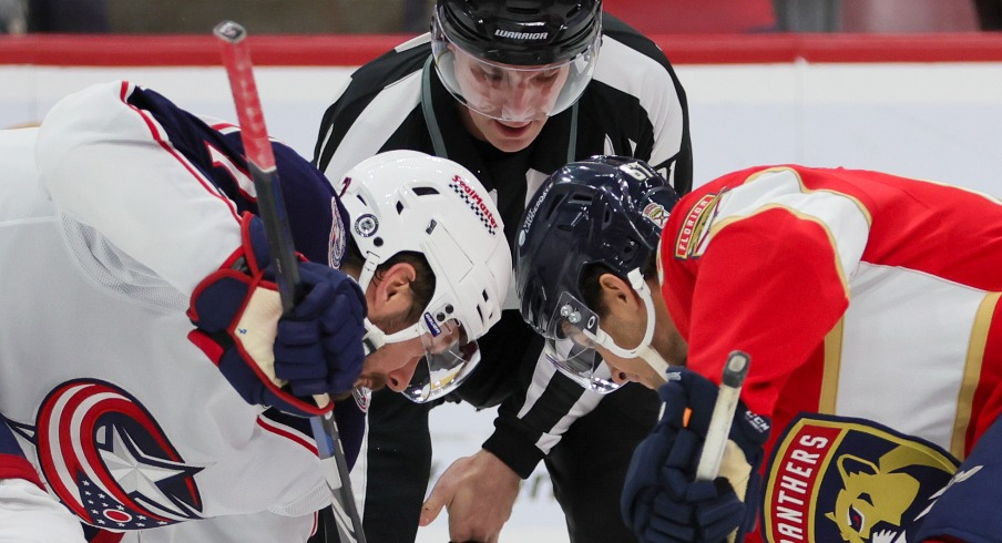 Columbus Blue Jackets center Sean Kuraly (7) and Florida Panthers right wing William Lockwood (67) face-off during the second period at Amerant Bank Arena.