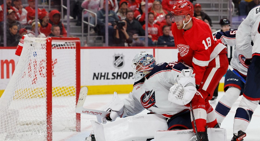 Columbus Blue Jackets goaltender Spencer Martin (30) makes a save in front of Detroit Red Wings center Andrew Copp (18) in the second period at Little Caesars Arena.