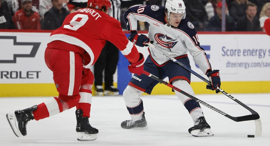 Columbus Blue Jackets' Dmitri Voronkov skates with the puck against Detroit Red Wings' Ben Chiarot in the first period at Little Caesars Arena.