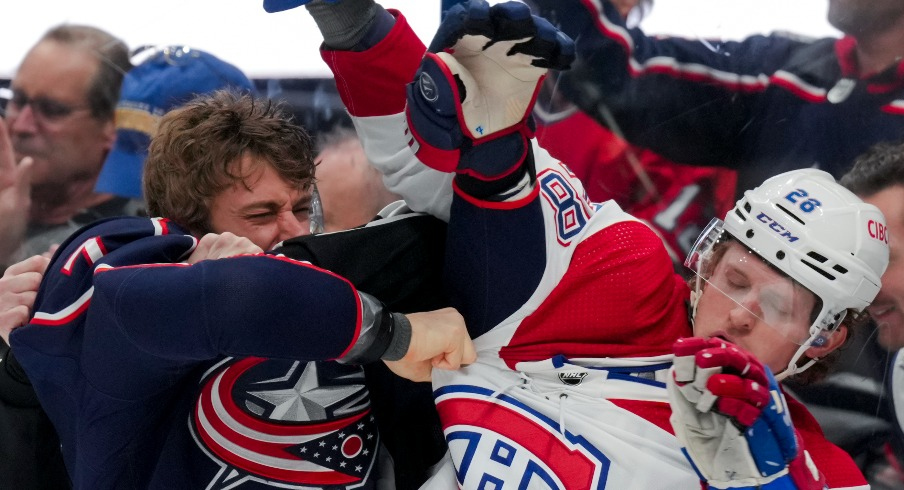 Columbus Blue Jackets center Sean Kuraly (7) scrums with Montreal Canadiens center Christian Dvorak (28) during a stop in play in the second period at Nationwide Arena.