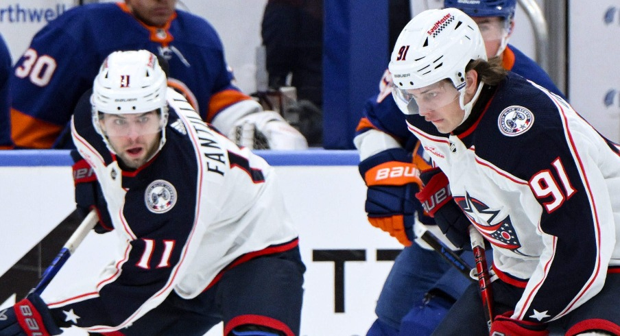 Columbus Blue Jackets center Kent Johnson (91) controls the puck as New York Islanders defenseman Noah Dobson (8) defends during the first period at UBS Arena.
