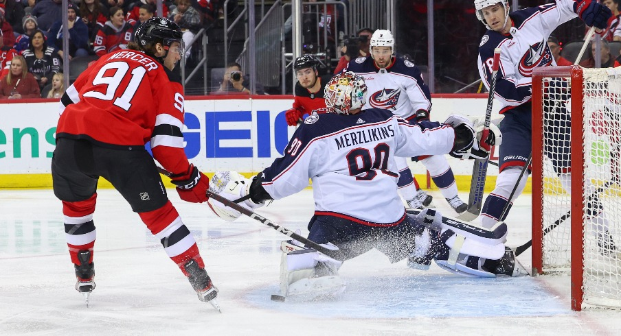 Columbus Blue Jackets goaltender Elvis Merzlikins (90) makes a save on New Jersey Devils center Dawson Mercer (91) during the second period at Prudential Center.