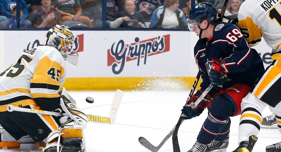 Pittsburgh Penguins goalie Magnus Hellberg (45) makes a save as Columbus Blue Jackets right wing Jordan Dumais (69) looks for a rebound during the second period at Nationwide Arena.