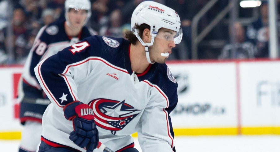 Columbus Blue Jackets forward Cole Sillinger(4) skates in on Winnipeg Jets defenseman Brenden Dillon (5) during the first period at Canada Life Centre.