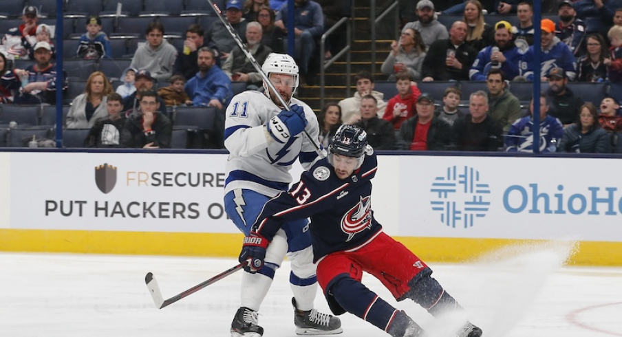 Columbus Blue Jackets' Johnny Gaudreau and Tampa Bay Lightning's Luke Glendening chase down a loose puck during the third period at Nationwide Arena.