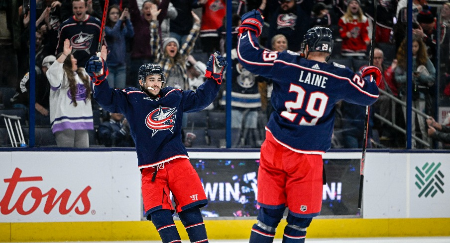 Columbus Blue Jackets left wing Johnny Gaudreau (13) celebrates his game winning goal against the Los Angeles Kings with Columbus Blue Jackets left wing Patrik Laine (29) in overtime at Nationwide Arena.