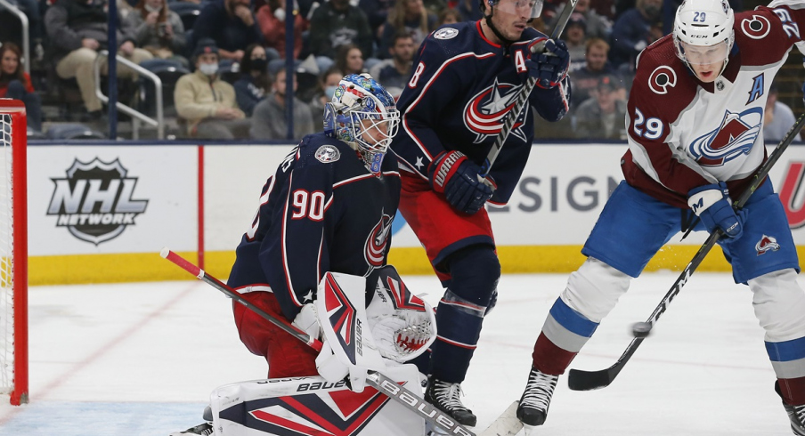 Nathan MacKinnon tips the puck on goal against the Columbus Blue Jackets