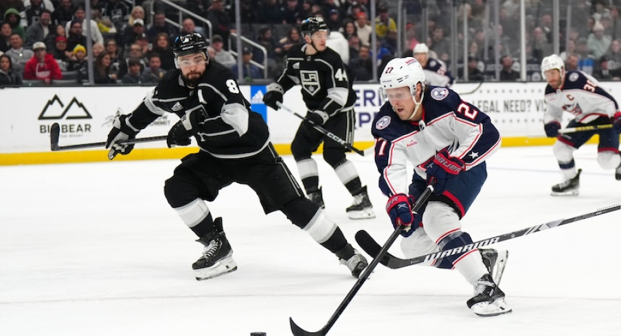 Columbus Blue Jackets' Adam Boqvist skates with the puck against the LA Kings' Drew Doughty in the third period at Crypto.com Arena.