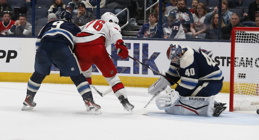 Carolina Hurricanes' Brady Skjei slides the puck through the pads of Columbus Blue Jackets' Daniil Tarasov for a gaol during the second period at Nationwide Arena.