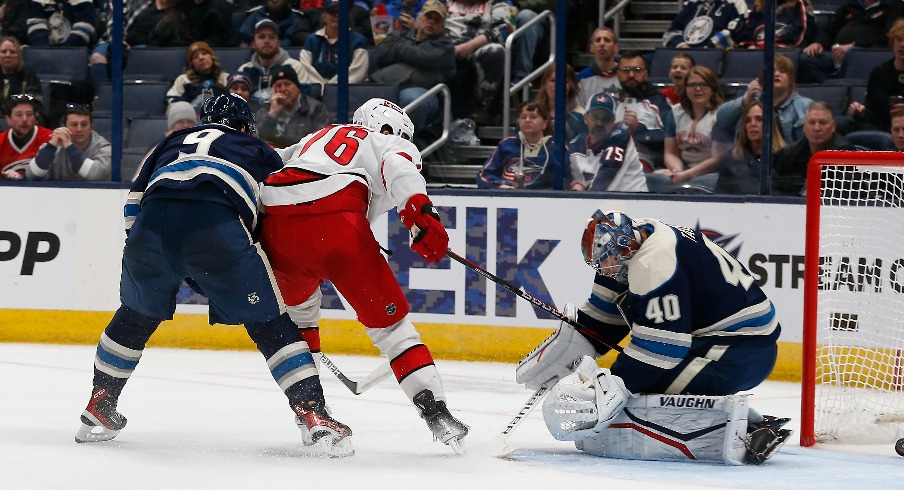 Carolina Hurricanes defenseman Brady Skjei (76) slides the puck through the pads of Columbus Blue Jackets goalie Daniil Tarasov (40) for a gaol during the second period at Nationwide Arena.