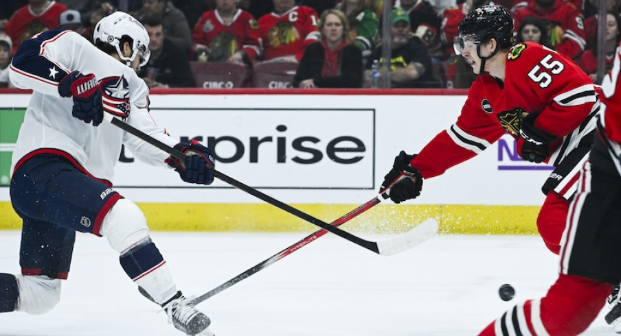 Columbus Blue Jackets' Cole Sillinger shoots the puck against Chicago Blackhawks' Kevin Korchinski during the first period at the United Center.