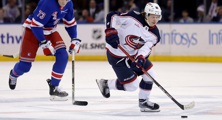 Columbus Blue Jackets center Kent Johnson (91) skates with the puck against New York Rangers center Matt Rempe (73) during the first period at Madison Square Garden.