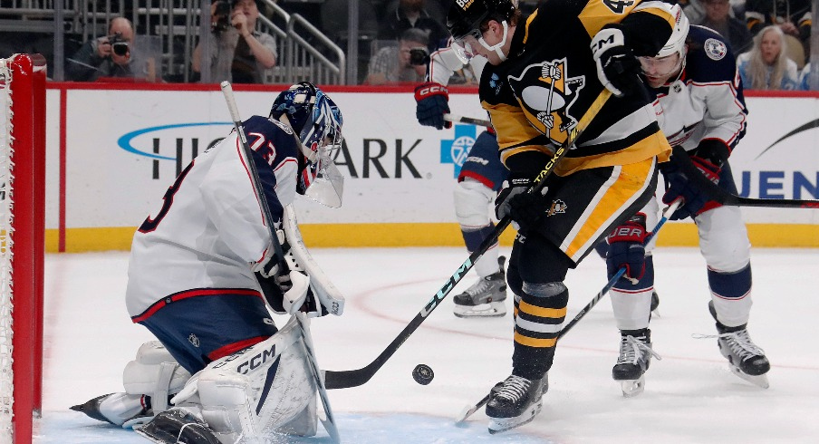 Columbus Blue Jackets goaltender Jet Greaves (73) makes a save against Pittsburgh Penguins right wing Valtteri Puustinen (48) during the first period at PPG Paints Arena.