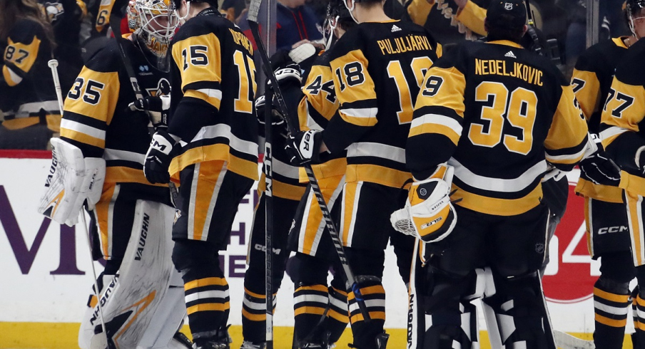The Pittsburgh Penguins celebrate after defeating the Columbus Blue Jackets at PPG Paints Arena