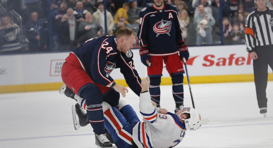 Columbus Blue Jackets' Mathieu Olivier and Edmonton Oilers' Sam Carrick fight during the first period at Nationwide Arena.