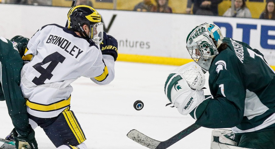 Michigan State goaltender Trey Augustine makes a save against Michigan right wing Gavin Brindley during the third period at Yost Ice Arena in Ann Arbor on Friday, Feb. 9, 2024.