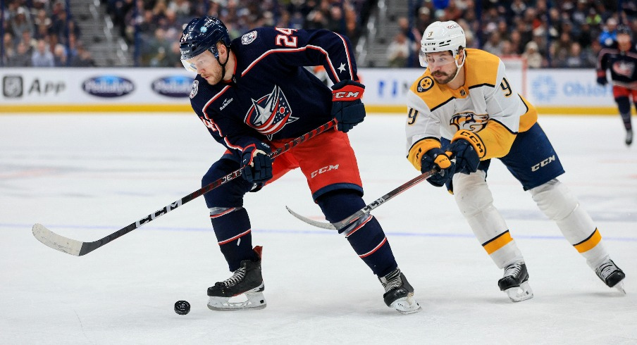 Columbus Blue Jackets right wing Mathieu Olivier (24) controls the puck against Nashville Predators left wing Filip Forsberg (9) in the second period at Nationwide Arena.