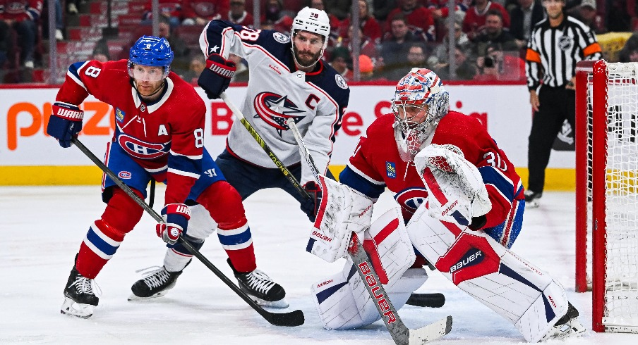 Montreal Canadiens goalie Cayden Primeau (30) tracks the play beside defenseman Mike Matheson (8) and Columbus Blue Jackets center Boone Jenner (38) during the second period at Bell Centre.