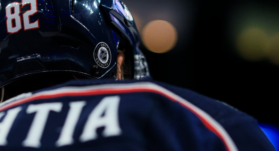 The NHL Unity and Equality sticker on the helmet of Columbus Blue Jackets left wing Mikael Pyyhtia (82) is seen as he skates during warmups prior to the game against the Buffalo Sabres at Nationwide Arena.