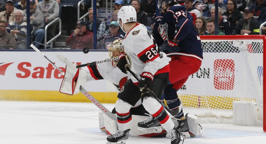 Ottawa Senators' Anton Forsberg makes a blocker save as Columbus Blue Jackets' Alexander Nylander looks for a rebound during the first period at Nationwide Arena.