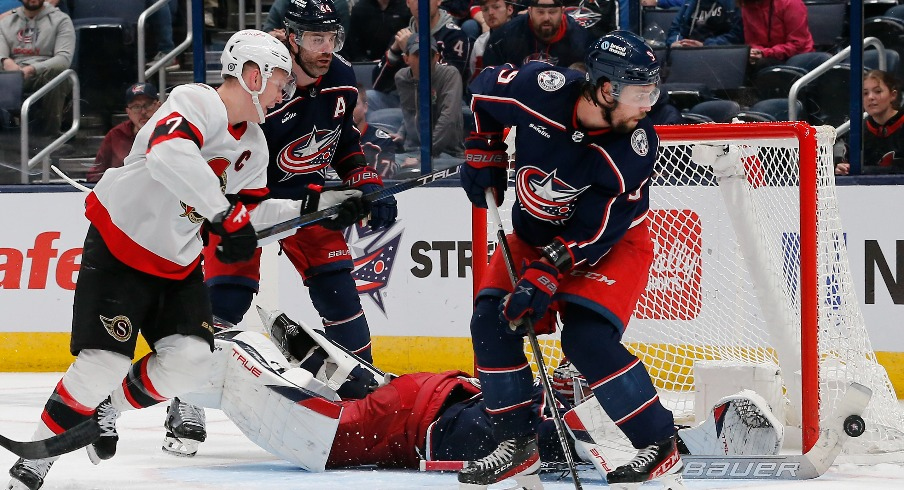 Columbus Blue Jackets goalie Elvis Merzlikins (90) makes a stick save against the Ottawa Senators during overtime at Nationwide Arena.