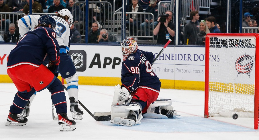 Winnipeg Jets right wing Tyler Toffoli (73) shot attempt slides wide of the goal against the Columbus Blue Jackets during the first period at Nationwide Arena.