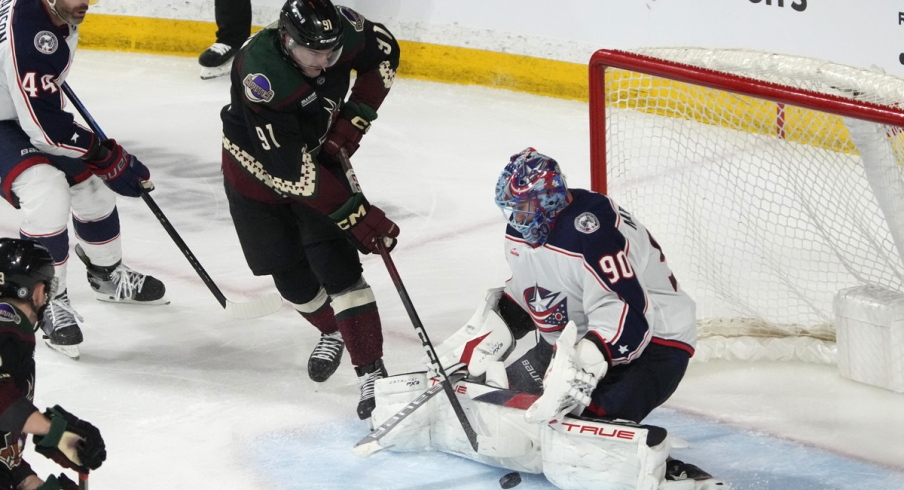 Columbus Blue Jackets goaltender Elvis Merzlikins makes a save on Arizona Coyotes right wing Josh Doan