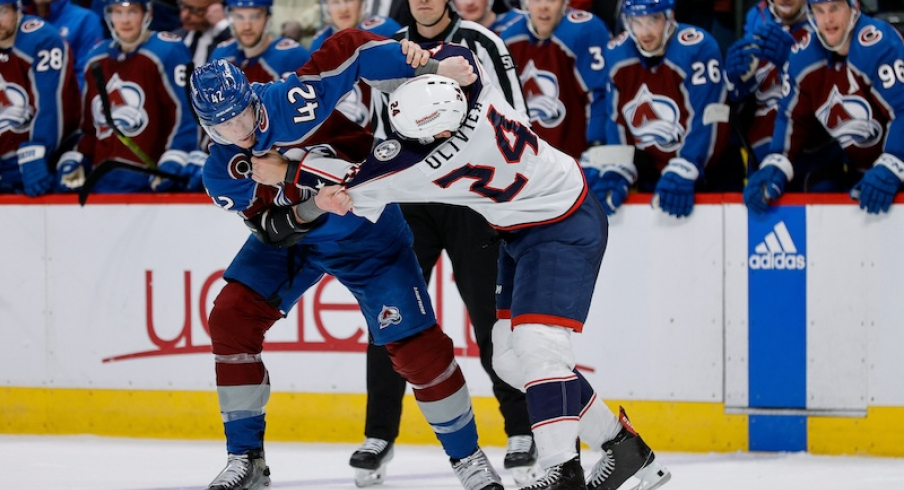 Colorado Avalanche's Josh Manson and Columbus Blue Jackets' Mathieu Olivier fight in the third period at Ball Arena.